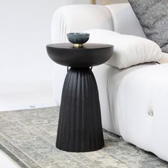 a black table sitting on top of a white couch