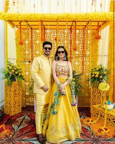 a man and woman dressed in yellow posing for a photo