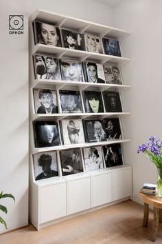 a white book shelf filled with books and pictures