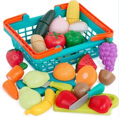 a basket filled with lots of different types of plastic vegetables and fruits in front of a white background