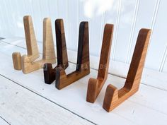 three wooden pieces of wood sitting on top of a white table next to each other