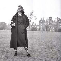 a woman standing in the middle of a field