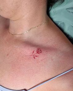 a woman with a rose tattoo on her chest