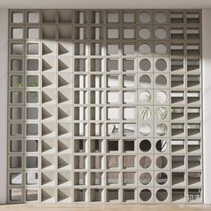 an abstractly designed room divider with circular holes in the center and small planters on each side