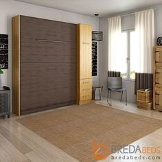 a living room with wooden furniture and large window in the corner, next to a beige carpeted area rug