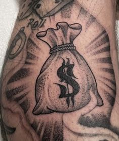 a man's arm with a tattoo on it and a bag in the middle