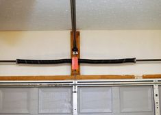 an overhead garage door is shown with the track in place to pull up or down