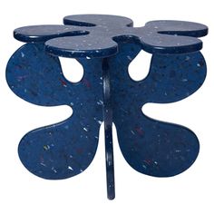 a blue table with four circular holes on it's sides and two smaller circles at the top