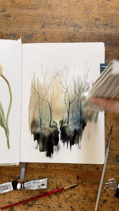 someone is painting trees in watercolor on paper