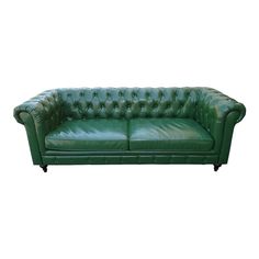 a green leather couch with buttons on the armrests and back rests against a white background