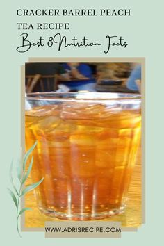 a glass filled with tea sitting on top of a wooden table