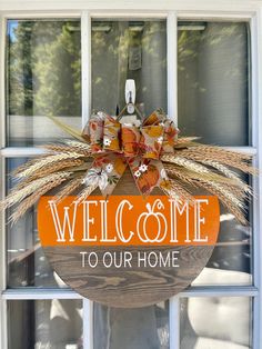 a welcome to our home sign hanging on a window