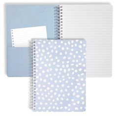 two notebooks with white polka dots on blue and gray paper next to each other