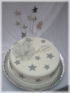 a white cake with silver stars on it