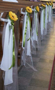 sunflowers tied to pews at a church