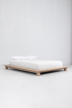 the bed is made up and ready for someone to use it in their home or office