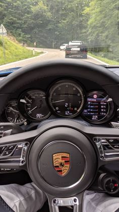 the dashboard of a porsche car on a road