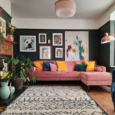 a living room filled with furniture and pictures on the wall