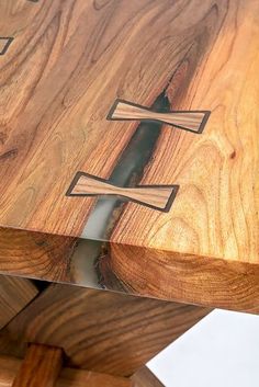 a close up of a wooden table with metal handles