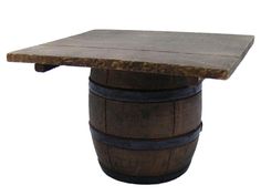 a wooden barrel with a table top on it's end, sitting in front of a white background