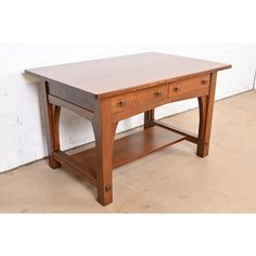 a small wooden table with two drawers on one side and an open shelf underneath it