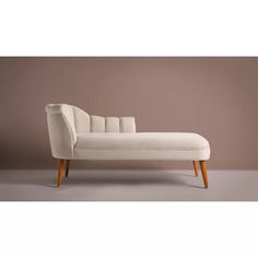 a white chaise lounge with wooden legs