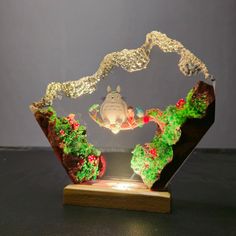 a glass sculpture with a frog on it