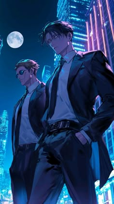 two men in suits and ties standing next to each other with city lights behind them