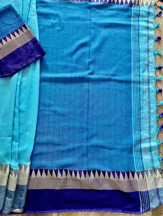 Beautiful Handloom Saree different shades of Ocean Colors (Blue) with Temple Borders Saree in Pure Khaadi. Item : Saree Color : Blue Base Fabric : Pure Khaadi Handloom Blouse piece : Comes with un-stitched Blouse piece. Blouse material : Pure Khaadi Handloom Work : Handloom Saree Fall & Edging : Comes with Fall and edging (Pico) done and Tassels attached Kindly note : Since this Saree is handmade hence little inconsistencies may be there however it is not considered as a defect. Every Saree Blue Slub Silk Traditional Wear For Festivals, Blue Slub Silk Saree Set, Blue Pre-draped Saree With Zari Weaving For Navratri, Blue Slub Silk Sets For Diwali, Traditional Blue Pre-draped Saree With Dupatta, Blue Festive Unstitched Saree, Blue Slub Silk Sets For Festivals, Blue Cutdana Blouse Piece In Traditional Drape, Blue Blouse Piece With Cutdana In Traditional Drape