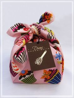 a small pink bag with a bow on it