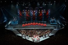 an aerial view of a concert with lots of people on the stage and in front of them