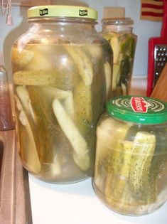 pickles in jars sitting on a kitchen counter