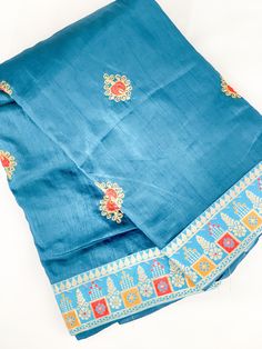 This soft silk saree comes in teal blue with border and authentic hand sticthed patterns. This saree includes a matching unstitched blouse piece which is customisable to fit all sizes. If you require the blouse to be stiched, We offer tailor service on request with additional cost. For more info please contact us and we will be happy to help.  🥻Occasion: Party, Sangeet, Wedding, Engagement, Outings, Bridal & festival. 🚚 Shipping : We offer International fast & secure shipping (Ask for more info) **Color may differ due to photography in light effect** Blue Silk Sets For Diwali, Blue Silk Set For Diwali, Blue Dola Silk Pre-draped Saree With Pallu, Dola Silk Pre-draped Saree With Embroidered Border For Puja, Blue Chanderi Salwar Kameez With Cutdana, Blue Raw Silk Pre-draped Saree For Festivals, Blue Dola Silk Pre-draped Saree For Eid, Festival Silk Pre-draped Saree With Embroidered Border, Bollywood Style Blue Pre-draped Saree With Resham Embroidery