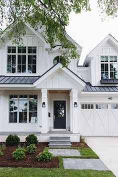 a white house with black trim and windows