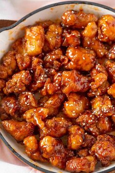 a bowl filled with chicken and sauce on top of a table