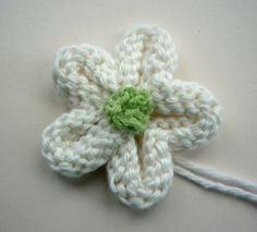 a crocheted flower with a green center