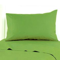 a bed with green sheets and pillows on it