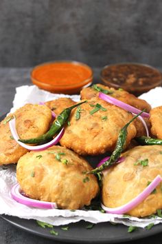 some fried food on a plate with sauces