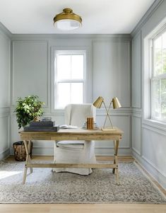 an image of a home office with gray walls and white furniture, including a desk