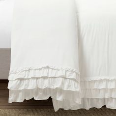 white bedding with ruffles on the bottom