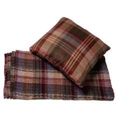 two plaid pillows sitting on top of each other