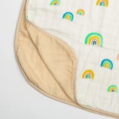 a baby bib with rainbows on it