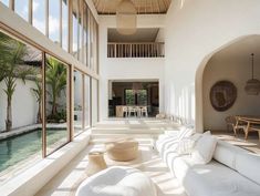 a living room filled with lots of white furniture