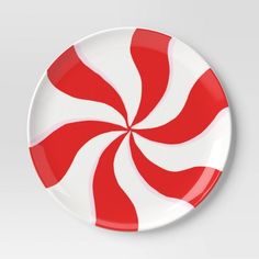 a red and white plate with a candy cane design on the front, against a gray background