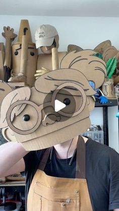 a man wearing an animal mask made out of cardboard