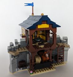 a lego model of a building with a clock on top