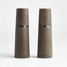 two gray salt and pepper shakers on a white background