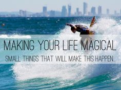 a man riding a wave on top of a surfboard in the ocean next to a city