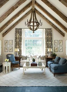 a living room filled with furniture and a chandelier