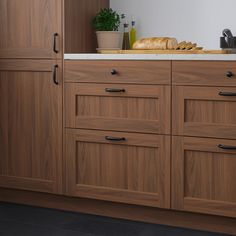 a kitchen with wooden cabinets and white counter tops